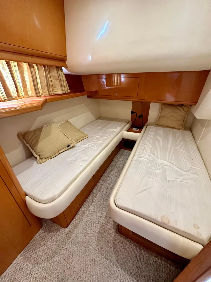 Slide: The Image of 2001 Uniesse 42 Open cabin with twin beds and wooden cabinetry. - 39