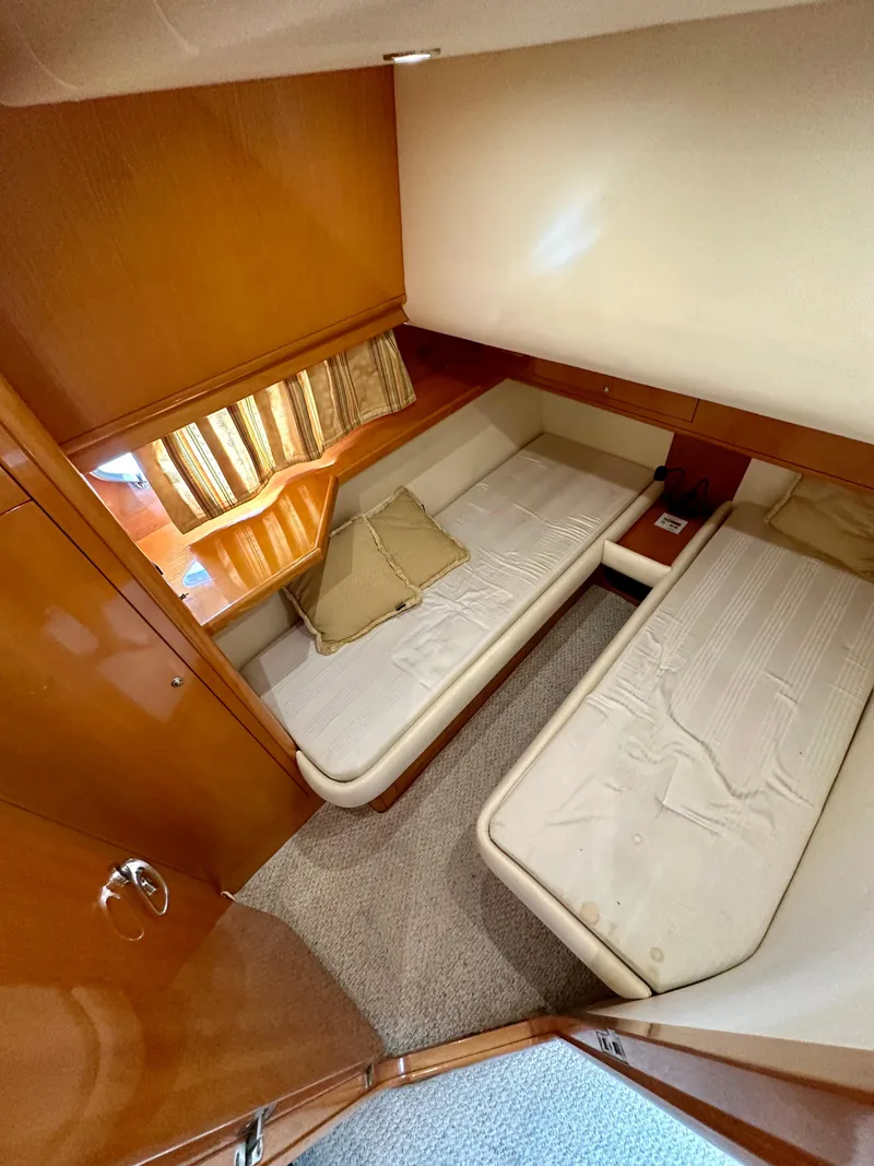 Slide: The Image of 2001 Uniesse 42 Open cabin with twin beds and wooden interior. - 43