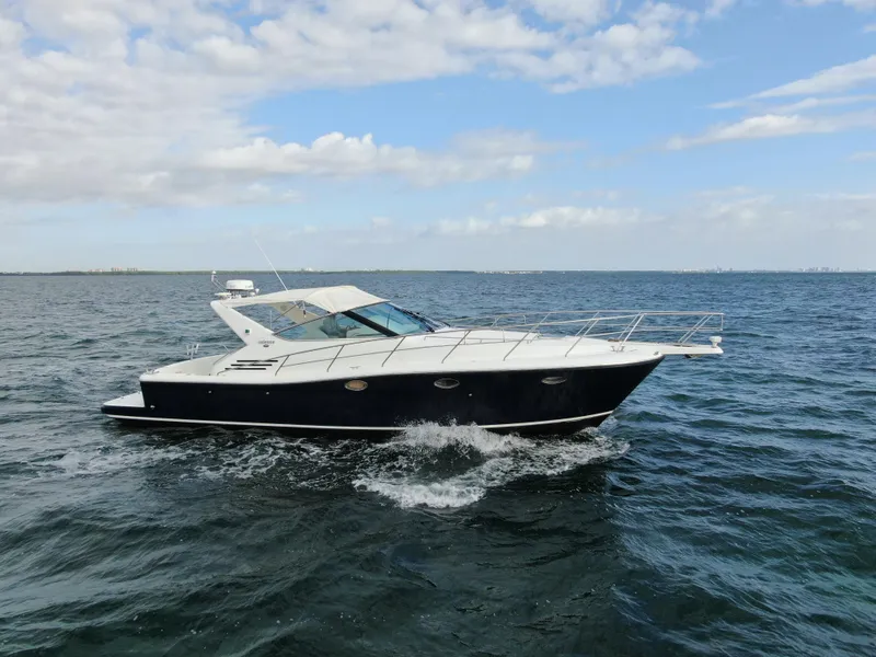 Slide: The Image of 2001 Uniesse 42 Open yacht cruising on open water under a partly cloudy sky. - 5