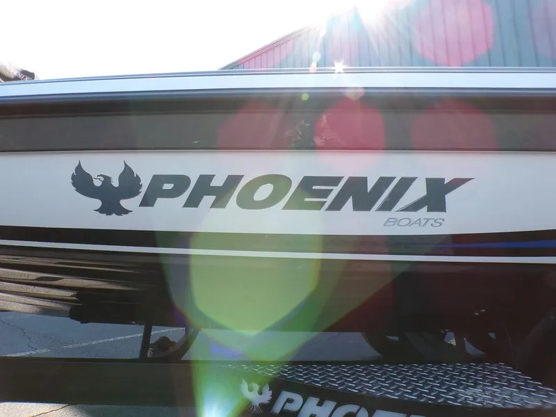 Slide: The Image of 2023 Phoenix 920 Elite boat with logo and sunlight reflections. - 12