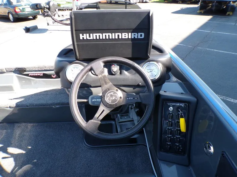 Slide: The Image of 2023 Phoenix 920 Elite boat dashboard with Humminbird electronics and steering wheel. - 15