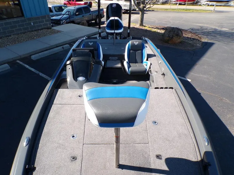 Slide: The Image of 2023 Phoenix 920 Elite fishing boat with blue and gray seating in a parking lot. - 17