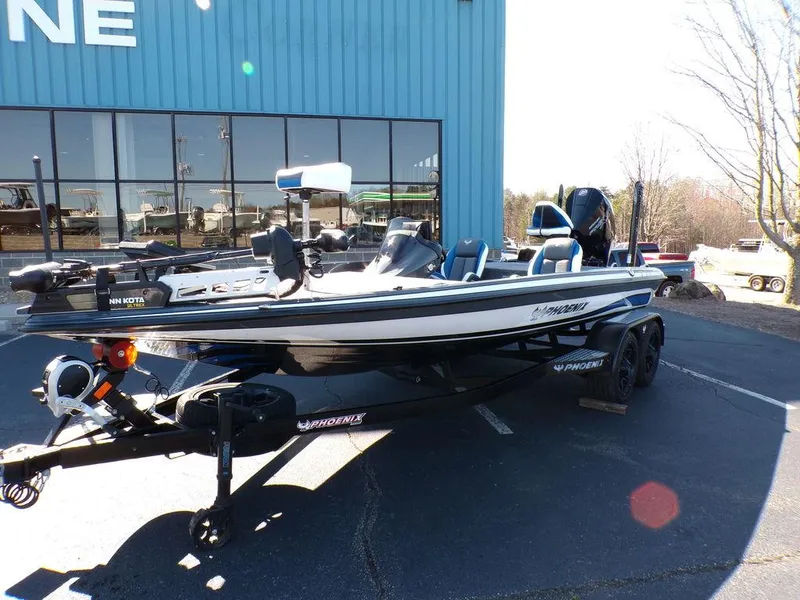 Slide: The Image of 2023 Phoenix 920 Elite fishing boat on trailer outside dealership. - 2