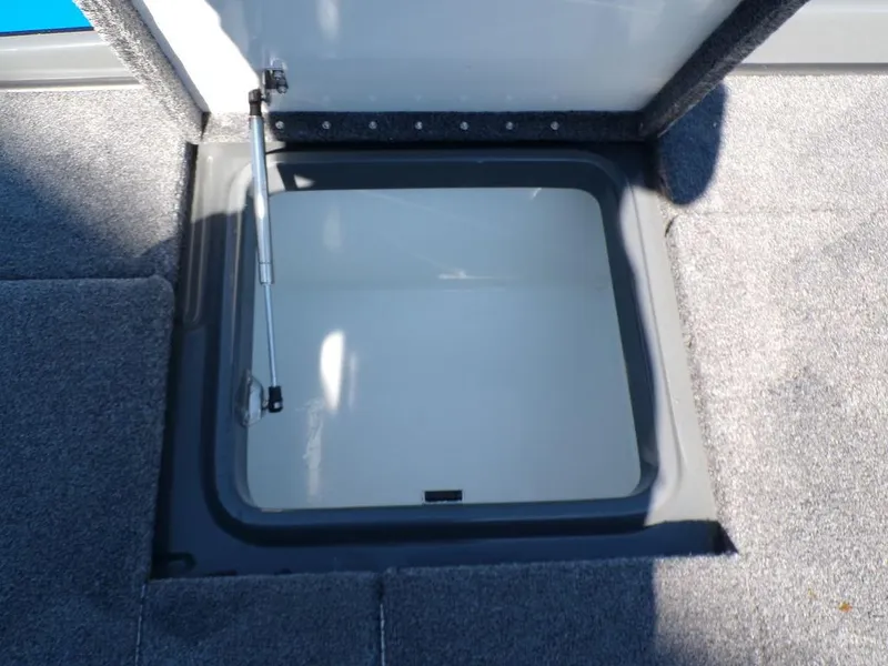 Slide: The Image of Open storage compartment in 2023 Phoenix 920 Elite boat. - 36