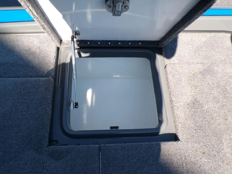 Slide: The Image of Open storage compartment of 2023 Phoenix 920 Elite boat. - 38