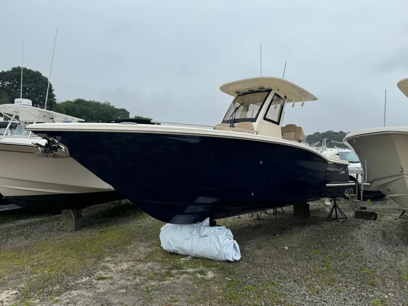Slide: The Image of 2025 Scout 260 LXF boat on display in a marina. - 11