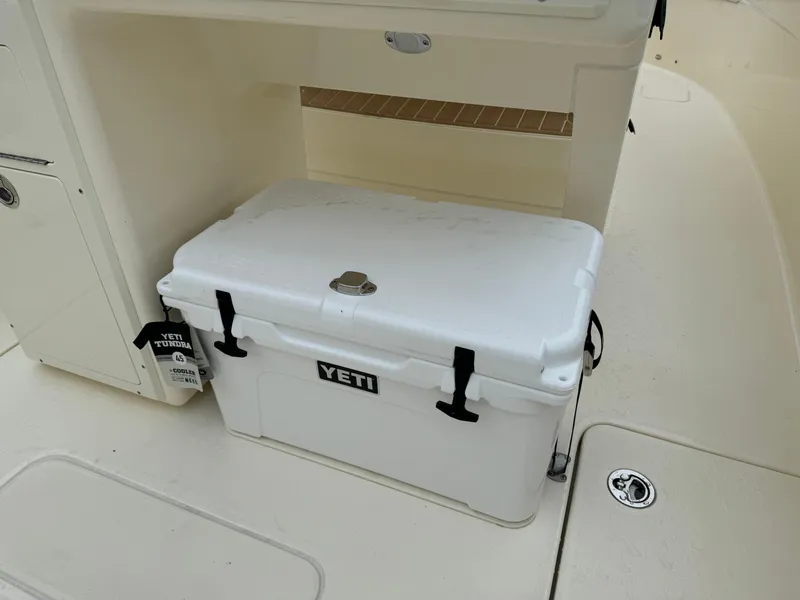 Slide: The Image of White YETI cooler on 2025 Scout 260 LXF boat deck. - 15