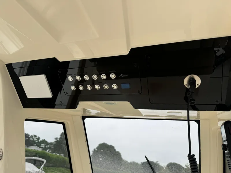 Slide: The Image of Control panel of 2025 Scout 260 LXF boat with buttons and microphone. - 17