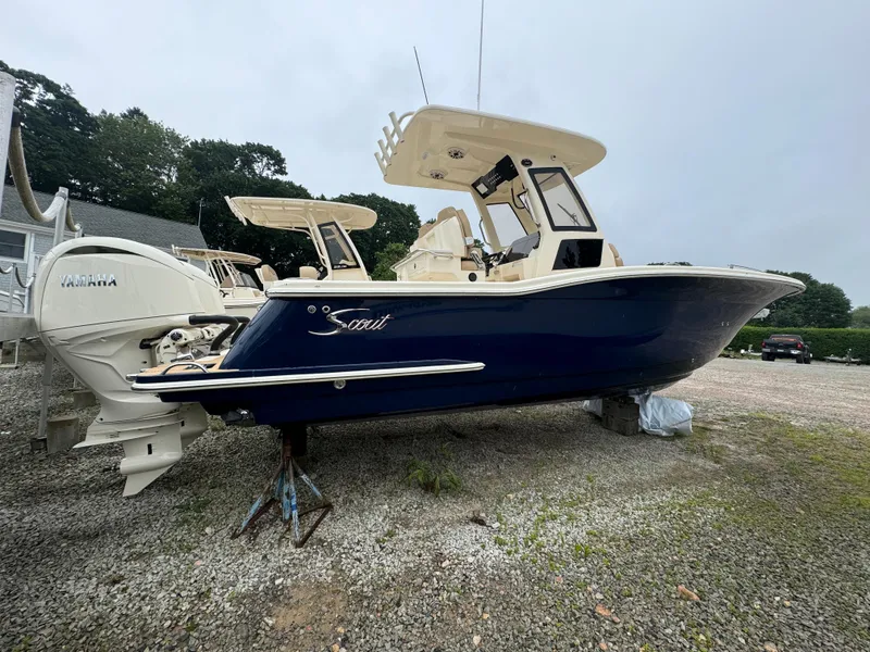 Slide: The Image of 2025 Scout 260 LXF boat on a gravel lot. - 2