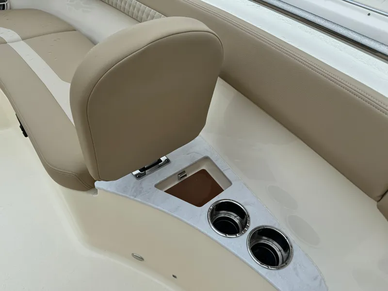 Slide: The Image of 2025 Scout 260 LXF boat interior with beige seating and cup holders. - 21