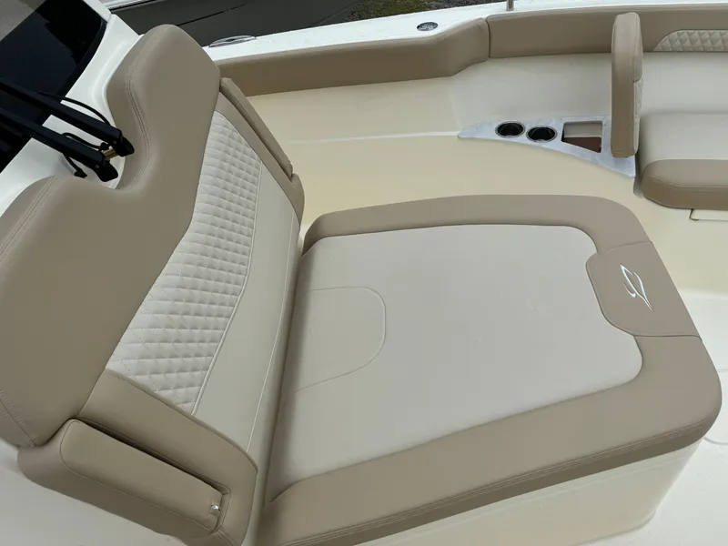 Slide: The Image of 2025 Scout 260 LXF boat with beige and cream cushioned seating. - 22