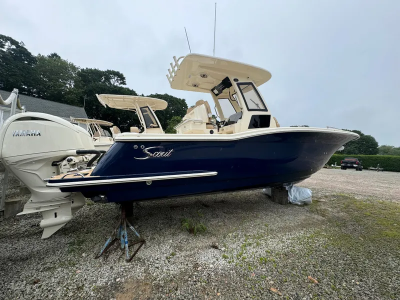 Slide: The Image of 2025 Scout 260 LXF boat with Yamaha outboard engines on gravel lot. - 3