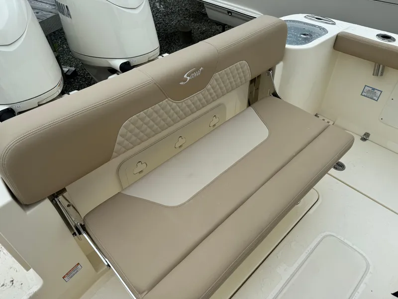 Slide: The Image of 2025 Scout 260 LXF boat with beige cushioned seating and dual outboard motors. - 32