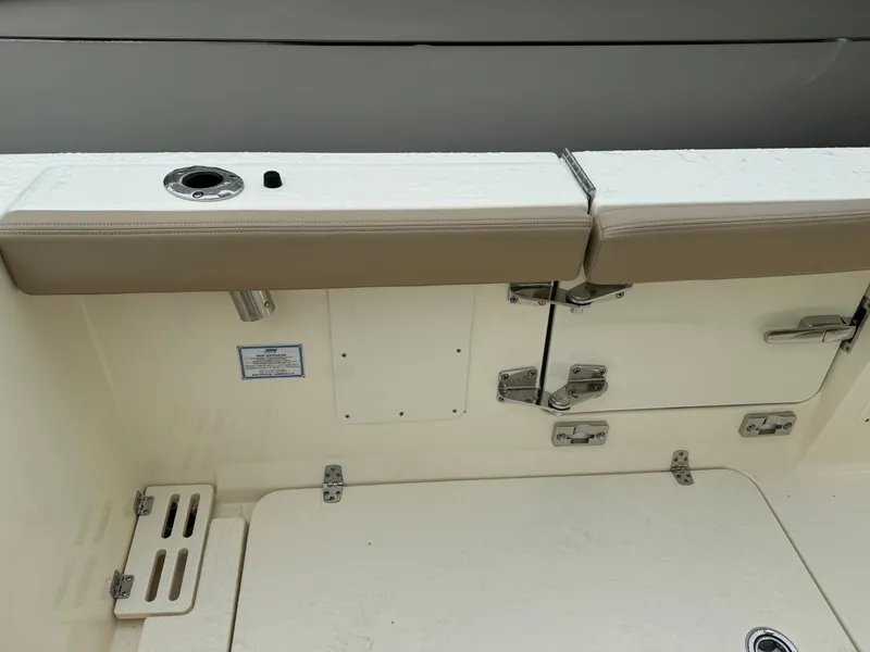 Slide: The Image of 2025 Scout 260 LXF boat interior with beige seating and storage compartments. - 34