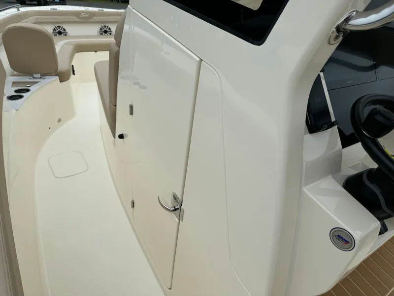 Slide: The Image of 2025 Scout 260 LXF boat interior with beige seating and storage compartment. - 36