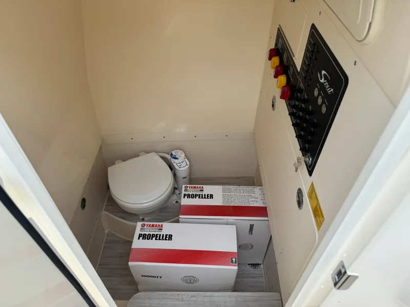 Slide: The Image of 2025 Scout 260 LXF boat interior with toilet and Yamaha propeller boxes. - 38