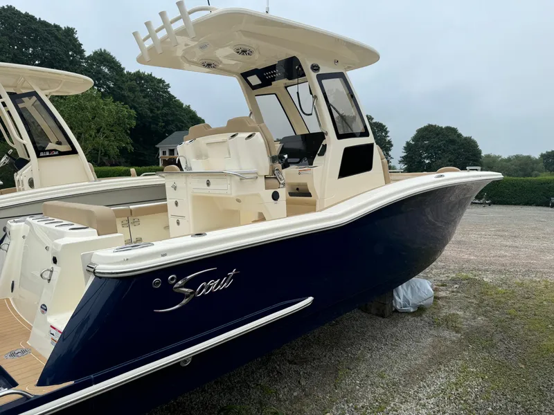 Slide: The Image of 2025 Scout 260 LXF boat with sleek design, parked outdoors. - 4