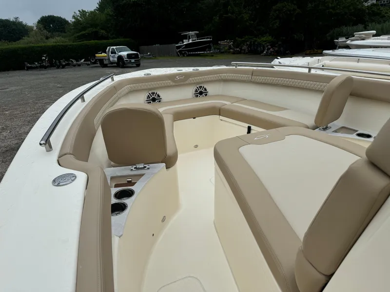 Slide: The Image of 2025 Scout 260 LXF boat interior with beige seating and cup holders. - 41