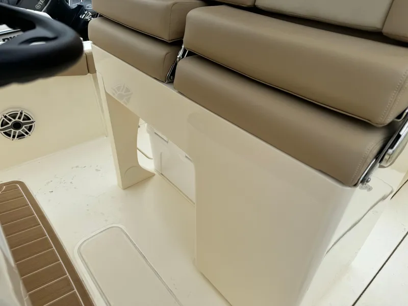 Slide: The Image of 2025 Scout 260 LXF boat interior with beige cushioned seating and white deck. - 44