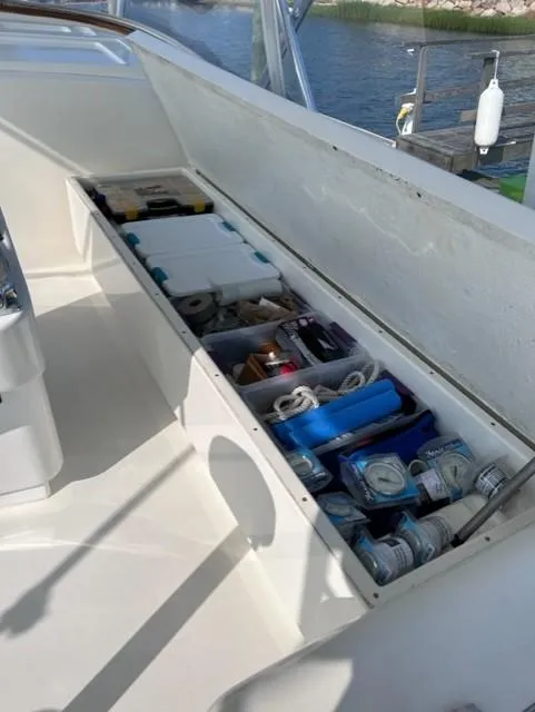 Slide: The Image of Storage compartment on a 2004 Stolper 38 boat, filled with various supplies and equipment. - 20
