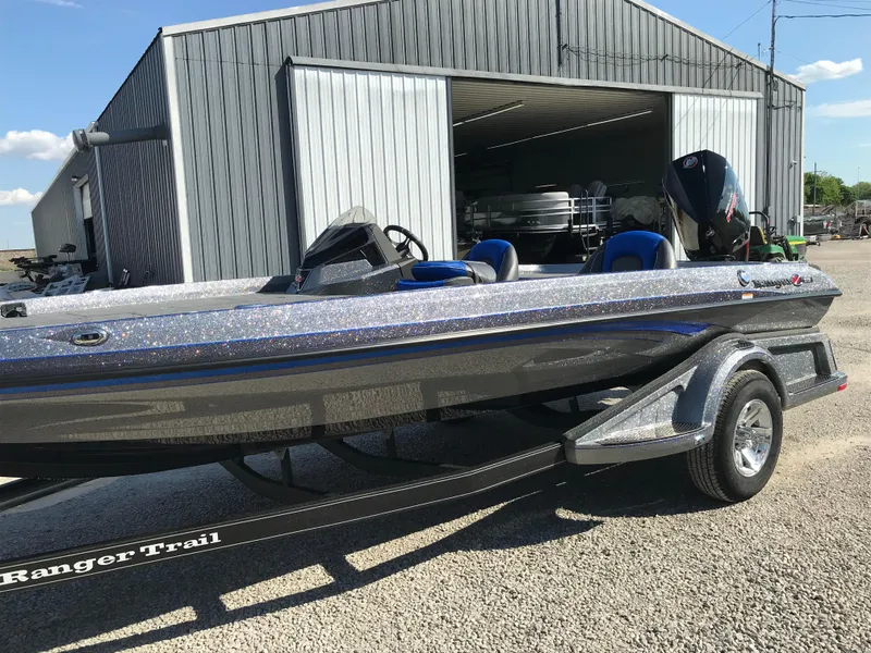 Slide: The Image of 2024 Ranger Z519 boat interior with open storage compartments and control panel. - 14