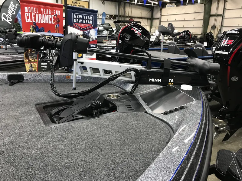 Slide: The Image of 2024 Ranger Z519 boat with mounted trolling motor in a showroom setting. - 18