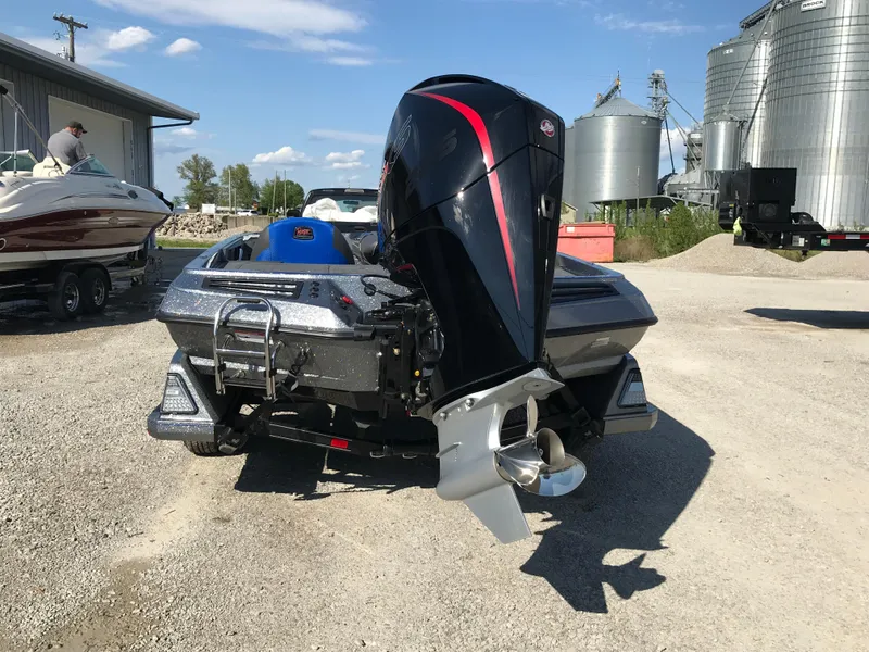Slide: The Image of 2024 Ranger Z519 boat on a trailer in an industrial area. - 4