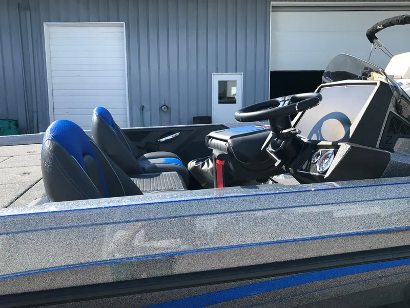 Slide: The Image of 2024 Ranger Z519 boat with powerful outboard motor, parked outdoors near industrial silos. - 5