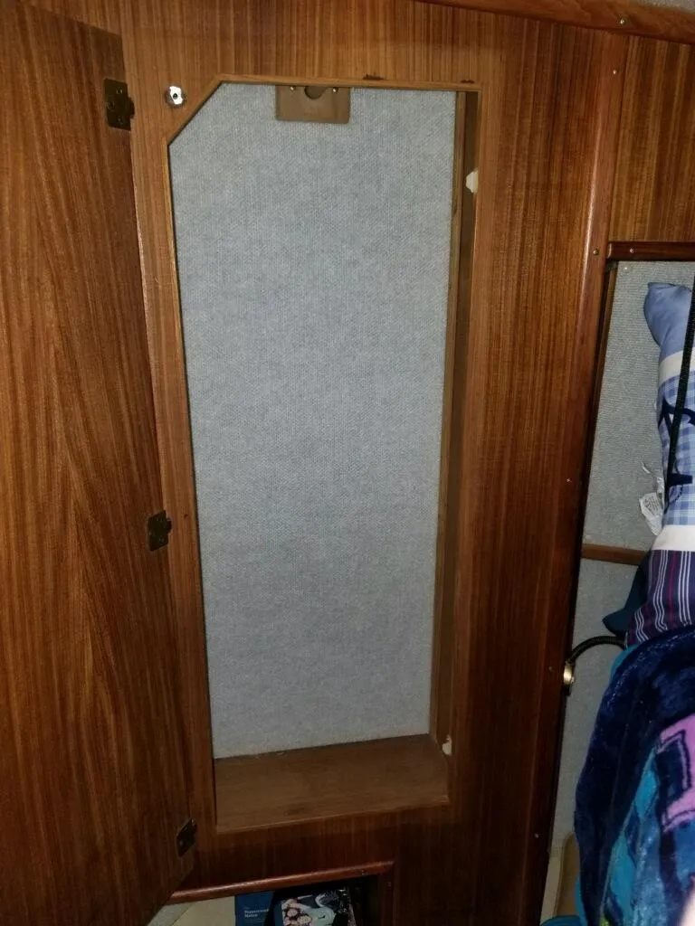 Slide: The Image of Wooden cabinet interior on a 1986 Sea Ray 390 Express boat. - 13