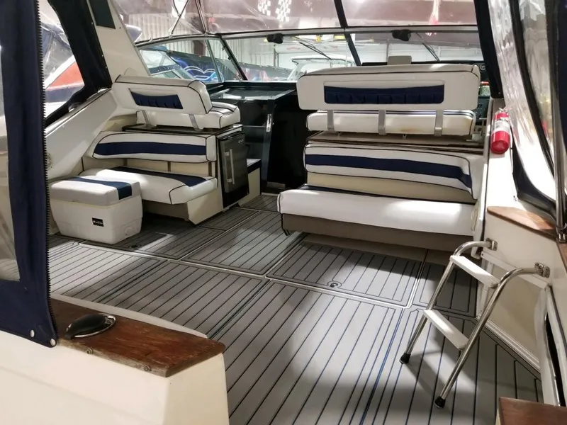 Slide: The Image of 1986 Sea Ray 390 Express boat interior with seating and helm station. - 14