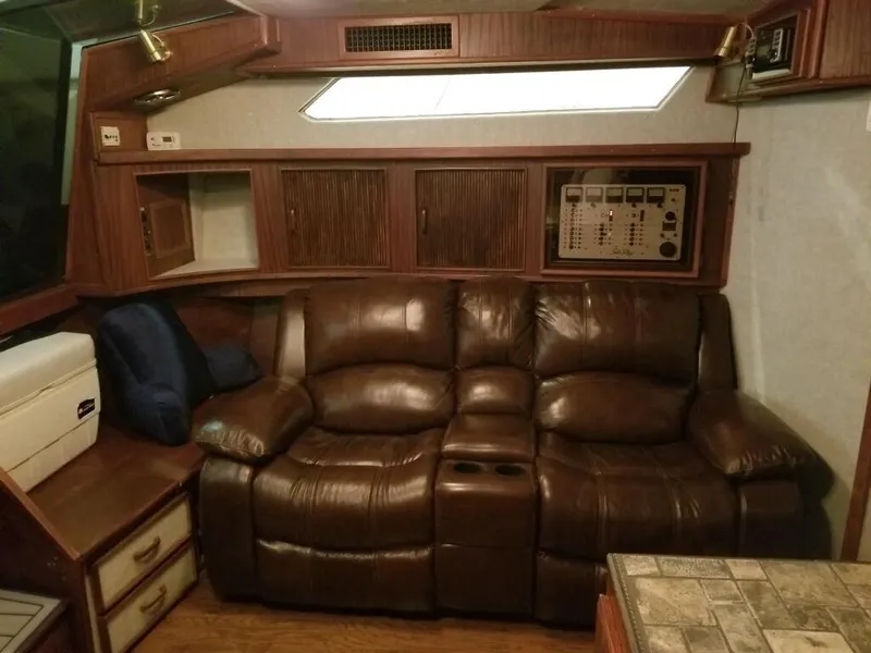 Slide: The Image of 1986 Sea Ray 390 Express cabin interior with leather sofa and wooden cabinetry. - 17