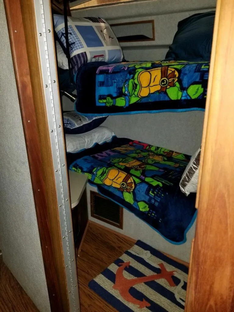 Slide: The Image of Bunk beds in 1986 Sea Ray 390 Express cabin with colorful bedding. - 7