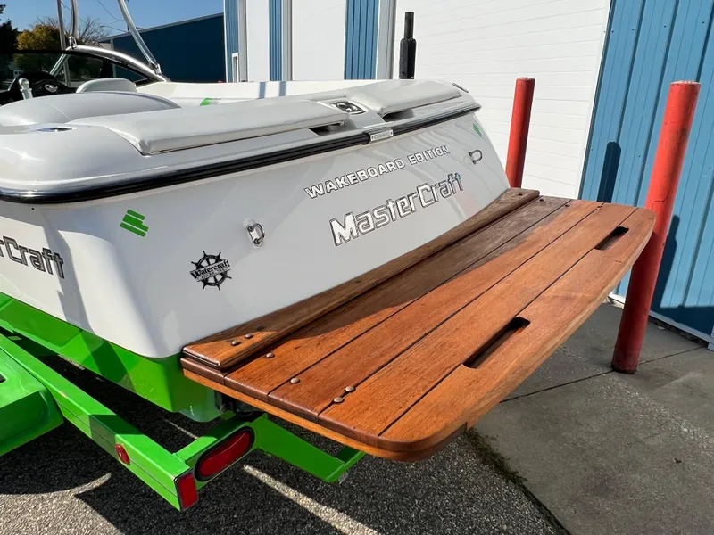 Slide: The Image of 2003 MasterCraft X5 Wakeboard Edition boat with wooden swim platform. - 1
