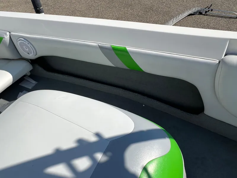 Slide: The Image of Interior of a 2003 MasterCraft X5 boat with white and green upholstery. - 10