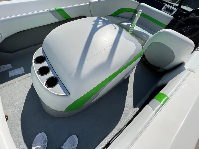 Slide: The Image of 2003 MasterCraft X5 boat interior with green accents and cup holders. - 13