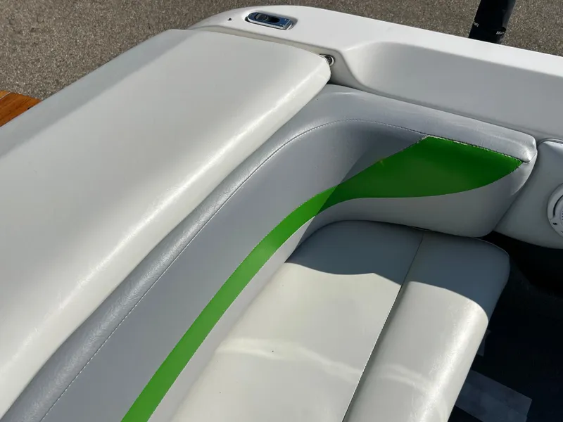 Slide: The Image of 2003 MasterCraft X5 boat interior with white and green upholstery. - 14