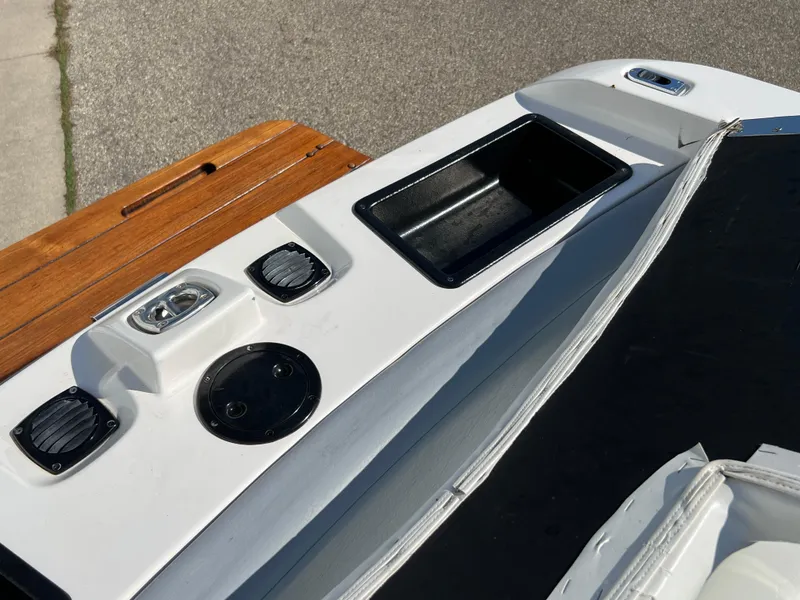 Slide: The Image of 2003 MasterCraft X5 boat stern with speakers, storage, and wooden swim platform. - 15