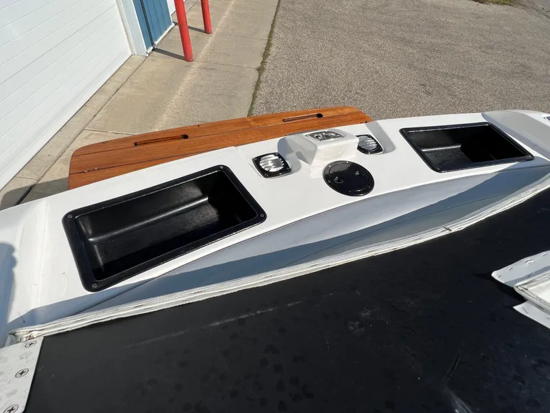 Slide: The Image of 2003 MasterCraft X5 boat dashboard and storage compartments. - 16