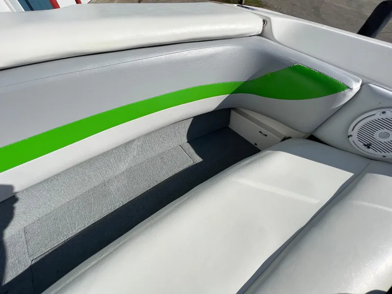 Slide: The Image of 2003 MasterCraft X5 boat interior with white, gray, and green upholstery. - 17