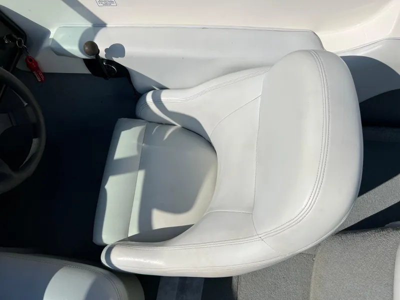 Slide: The Image of 2003 MasterCraft X5 boat interior with white leather seat. - 2