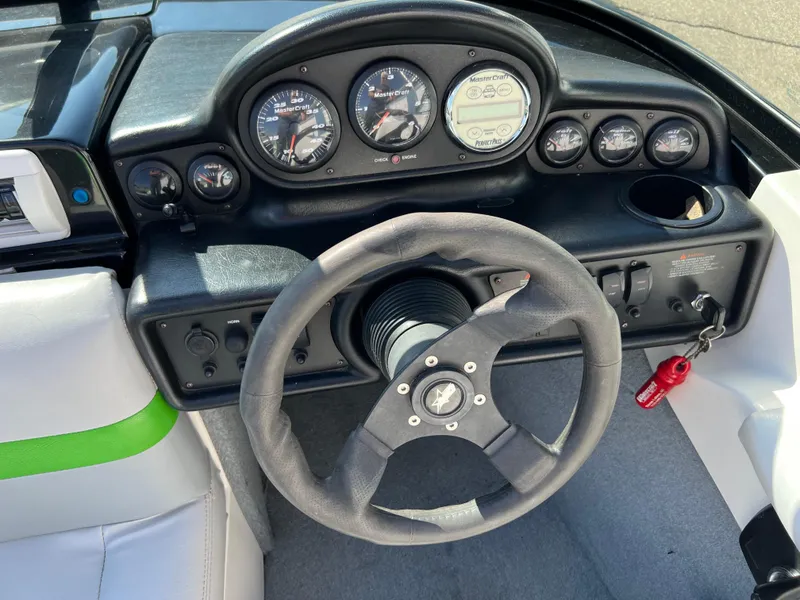 Slide: The Image of 2003 MasterCraft X5 boat dashboard with steering wheel and instrument panel. - 3