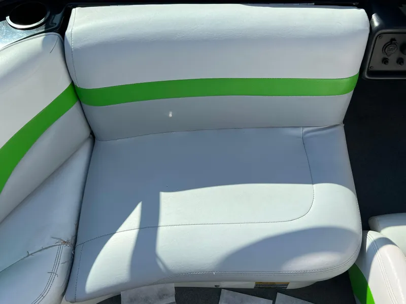 Slide: The Image of 2003 MasterCraft X5 boat interior with white and green upholstery. - 6