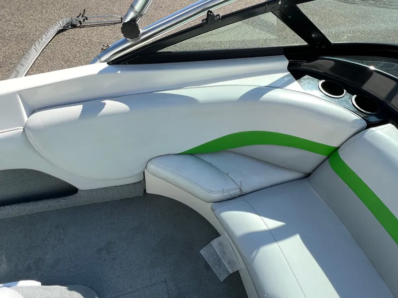 Slide: The Image of Interior of a 2003 MasterCraft X5 boat with white and green seating. - 7