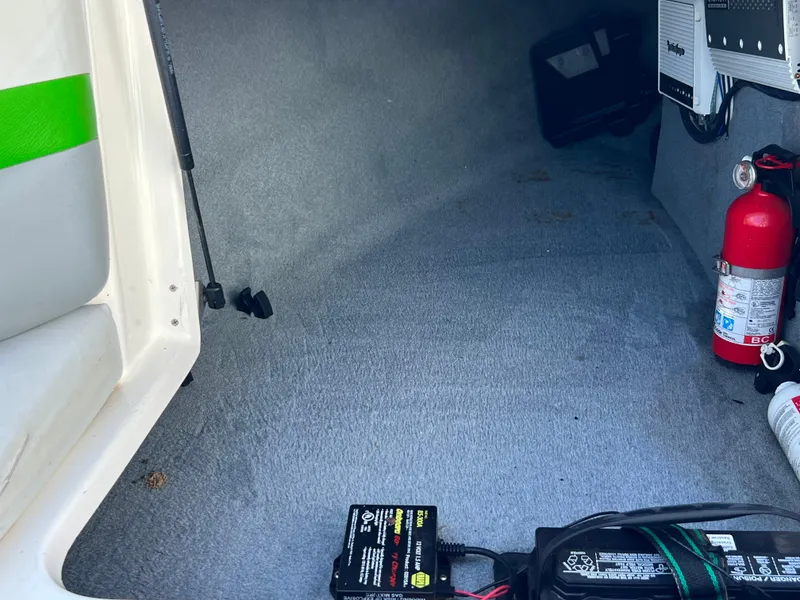 Slide: The Image of 2003 MasterCraft X5 boat interior storage with fire extinguisher and battery. - 8