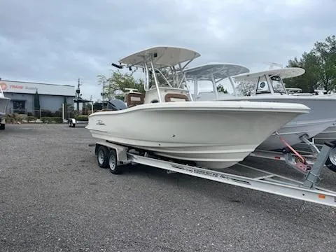 The Image of 2024 Pioneer 222 Islander boat on a trailer in a dealership lot. - 0