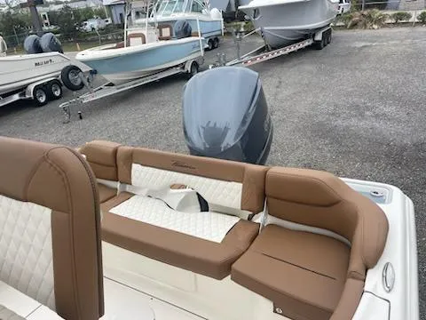 Slide: The Image of 2024 Pioneer 222 Islander boat with brown and white cushioned seating. - 4