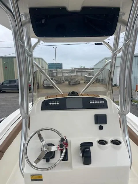 Slide: The Image of 2024 Pioneer 222 Islander boat with brown and white cushioned seating. - 6