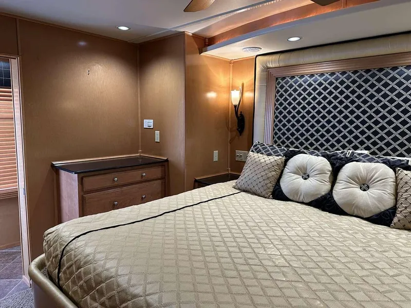 Slide: The Image of Luxurious bedroom interior in a 2005 Sumerset Top Hat houseboat, featuring elegant bedding and decor. - 19