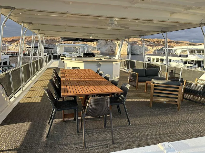 Slide: The Image of Luxurious 2005 Sumerset Top Hat yacht deck with dining area and lounge seating. - 24