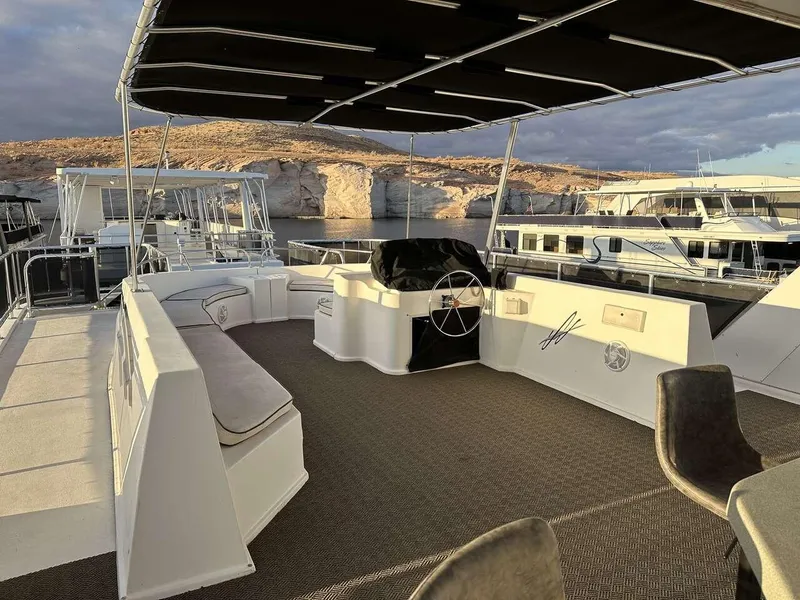 Slide: The Image of 2005 Sumerset Top Hat houseboat with shaded deck, steering wheel, and seating area. - 29